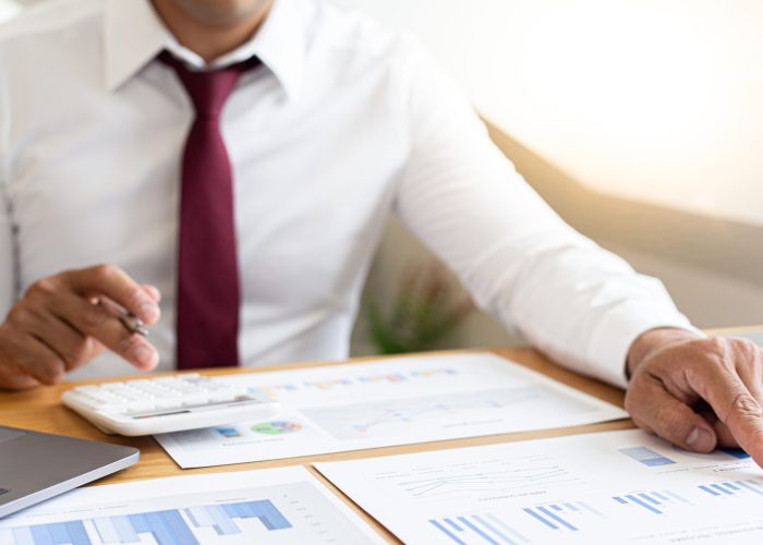 Financial businessman analyze the graph of the company's performance to create profits and growth, Market research reports and income statistics, Financial and Accounting concept.